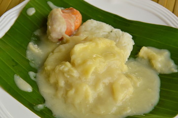 durian with sticky rice dressing coconut cream on banana leaf