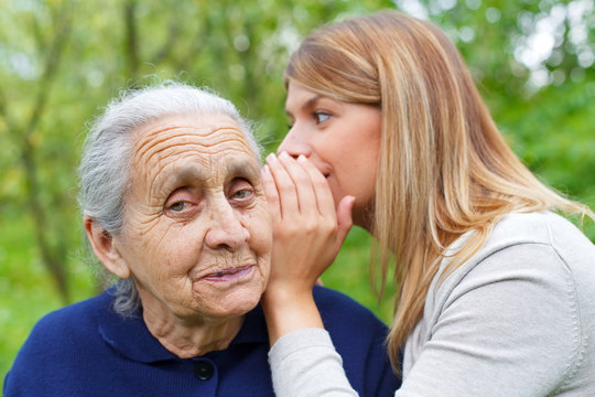 Whispering a secret to grandma's ear