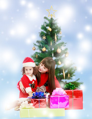 Mother with daughter near the Christmas tree