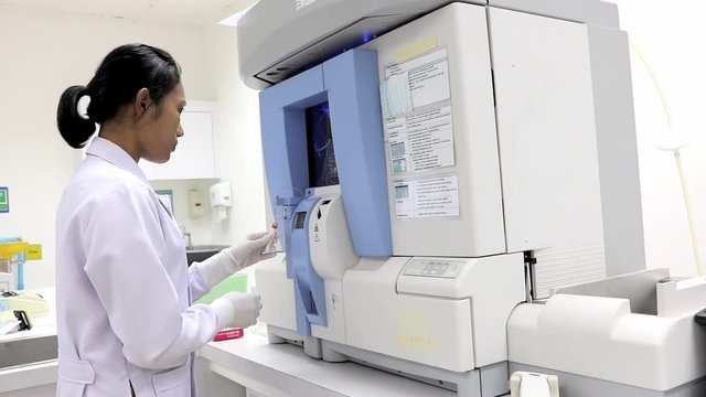 doctor testing blood with Hematology analyzer machine