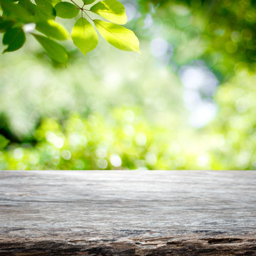 Empty wooden table with garden bokeh background with a country outdoor theme,Template mock up for display of product