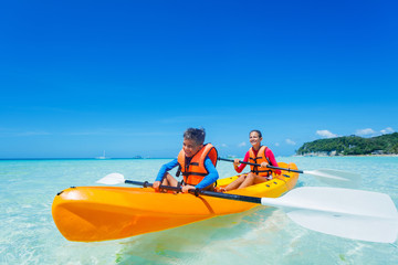 Kids paddling in kayak