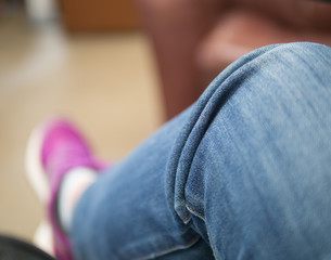 Selective focus at blue jean pant on leg