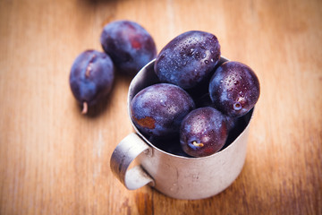 blue plums in cup