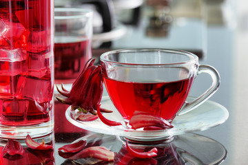 Cup of hot hibiscus tea (rosella, karkade) on kitchen table