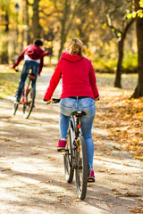Fototapeta na wymiar Urban biking - woman riding bike in city park 
