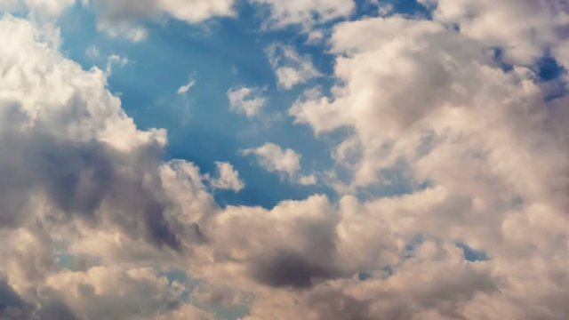 Time lapse clip of white fluffy clouds over sky