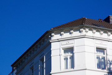 Historic Renaissance Revival architecture in the Frankenberger Quarter, Aachen, Germany with townhouses with ornate stone carving and dormer windows against a blue sky