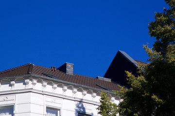 Historic Renaissance Revival architecture in the Frankenberger Quarter, Aachen, Germany with townhouses with ornate stone carving and dormer windows against a blue sky