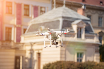 Drone is taking off from men hands. Young releasing copter to fly in the sunset field.