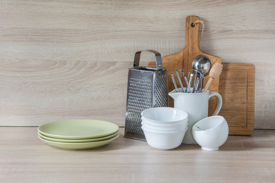 Crockery, tableware, utensils and other different stuff on wooden table-top. Kitchen still life as background for design.  Image with copy space.