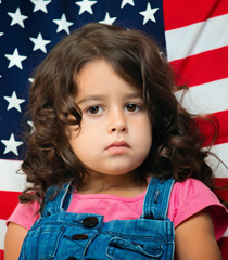 little girl against the backdrop of America flag