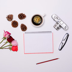 Blank paper with various objcects around it on white background
