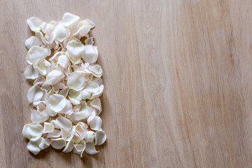 Creative arrangement made of different flowers on wooden background with space for text.