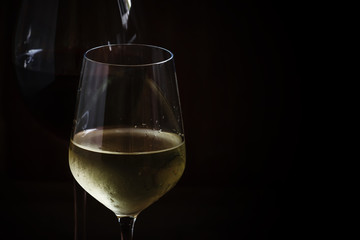 Red and white wine in glasses, dark background, low key, selecti