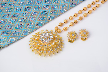 shiny gold jewelry on white background