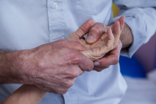 Physiotherapist Giving Hand Massage To A Patient