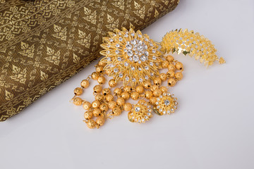 shiny gold jewelry on white background