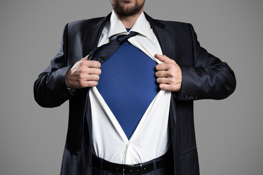 Businessman Acting Like A Super Hero And Tearing His Shirt