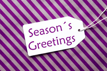 Label On Purple Wrapping Paper, Text Seasons Greetings