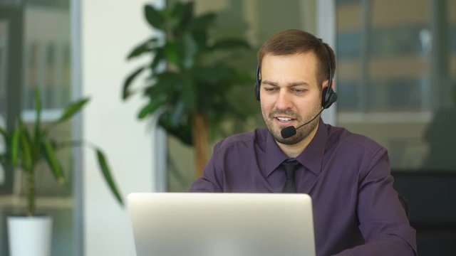 a smiling man with headset working as a call center operator