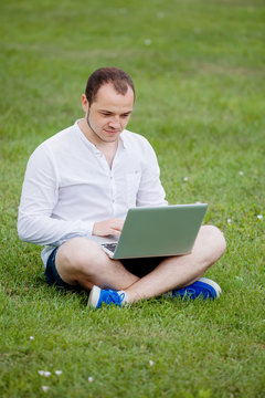 young man with laptop outdoor