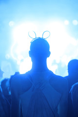 Man standing in front of a stage in cyan