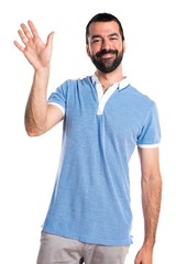 Man with blue shirt saluting