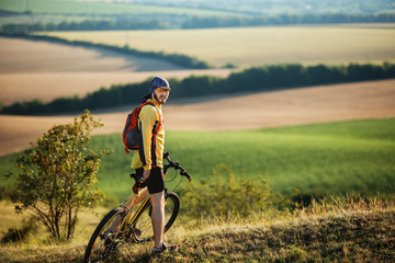 Young man cycling on a rural road