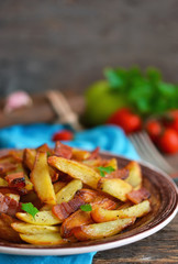 Young fried potatoes with bacon and onions