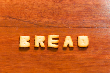 the word bread written with cracker
