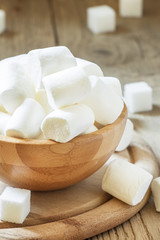 Big marshmallows in bowl, selective focus