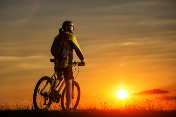 Obraz na płótnie Canvas Sporty Man Riding a Bicycle on the Country Road.