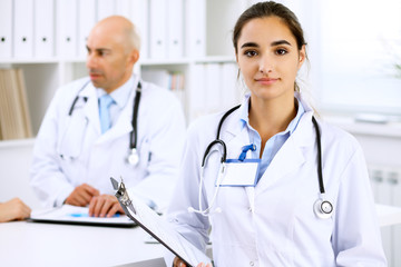 Happy doctor woman  with medical staff at the hospital