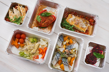 Healthy food take away in boxes, top view at wood