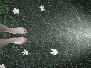 feet on grass and light on the ground