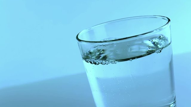 filling a glass with water, nutrition and health-care concept