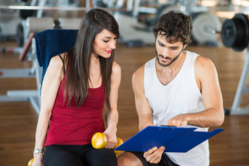 People reading a clipboard in a gym