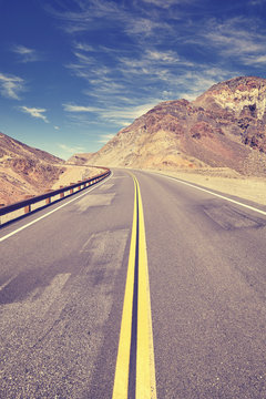Vintage toned mountain road in Death Valley, travel concept, USA.