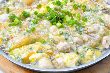 Close up oyster omelette on a hot pan