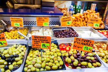Pickled olives in the Market in Barcelona. Selling and buying.