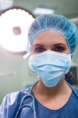 Fototapeta na wymiar Portrait of surgeon wearing surgical mask in operation room