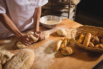 Fotobehang Mid-section of baker kneading a dough © WavebreakMediaMicro