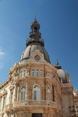Fototapeta na wymiar Beautiful facade of the City Hall of Cartagena, Spain, with bell and clock