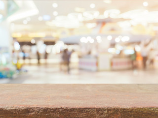 Stone board empty table in front of blurred background. Perspective brown stone over blur in coffee shop - can be used for display or montage mock up your products. vintage filtered image.