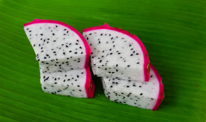 Dragon fruit.Pitaya.dragon fruit slice on green leaf banana
