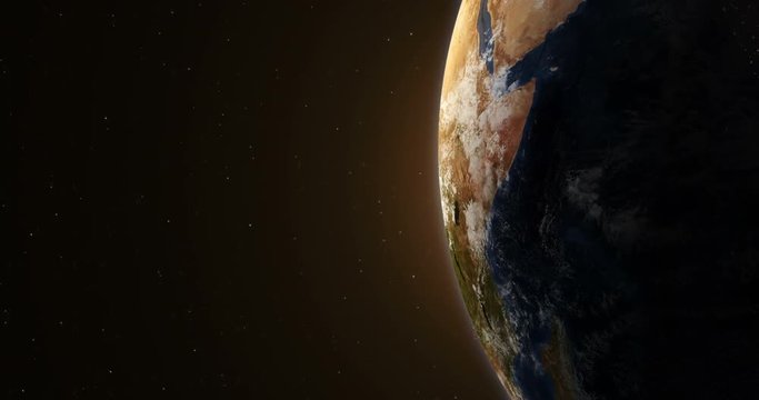 Planet earth at sunrise illuminated from the sun in the outer space