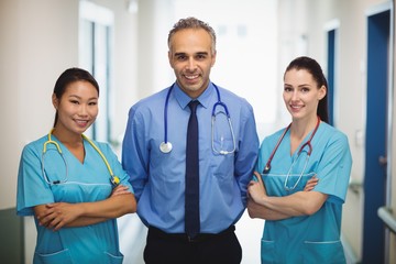 Portrait of doctor and nurses standing with arms crossed