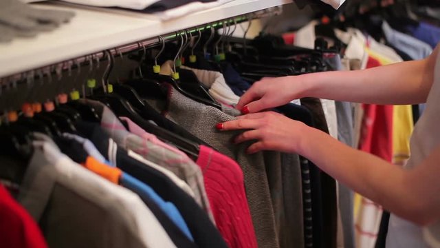 Woman look over some clothes at the shop