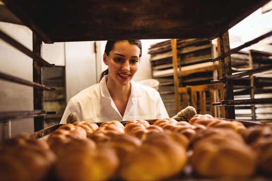 Female Baker Holding A Tray Of Michetta